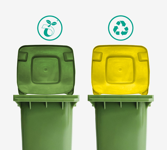 Two bins, one with a green lid with the compostable logo and one with a yellow lid with the recyclable logo